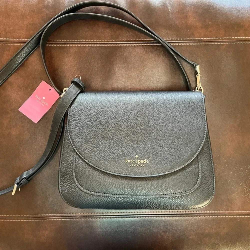 This is a NWT Kate Spade purse in black pebble leather with gold furnishings.